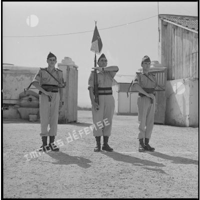 [Soldats d'une compagnie du 2e régiment de zouaves (RZ) présentant les armes au cantonnement de la ferme des Oliviers.]