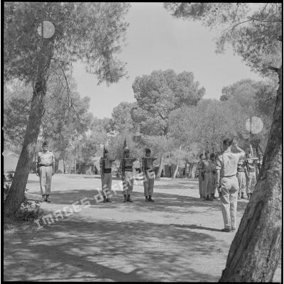[Soldats de la 5e compagnie du 2e régiment de zouaves (RZ) présentant les armes au campement de la forêt Moulay Ismaïl.]