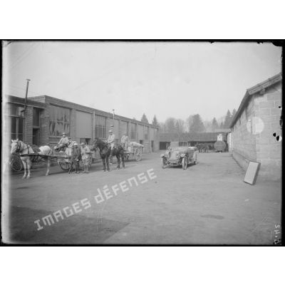 [Soldats à cheval dans la cour d'une usine.]