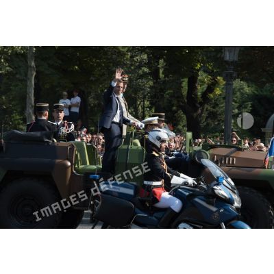 Monsieur Emmanuel Macron, président de la République française, remonte les Champs-Elysées à bord du "command car" lors du défilé militaire du 14 juillet 2018 à Paris.