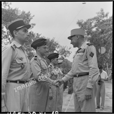 Le général Cogny, commandant en chef des FTNV (forces terrestres du Nord-Vietnam), félicite un chef de bataillon décoré de la Légion d'honneur à l'occasion de la Fête de Jeanne d'Arc.