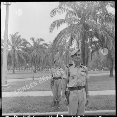 Portrait de deux officiers au garde-à-vous dans un parc d'HanoÏ.