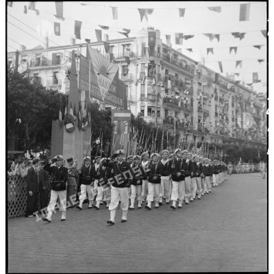 Défilé de fusiliers marins lors du 14 juillet 1943 dans une rue pavoisée d'Alger.