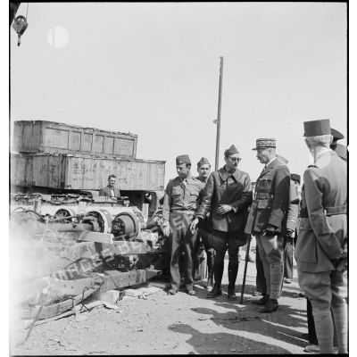 Dans le cadre du réarmement de l'armée française par les Etats-Unis, sur une chaîne de montage sur le port d'Alger, des essieux de véhicule sont présentés au général d'armée Henri Giraud, commandant en chef civil et militaire.