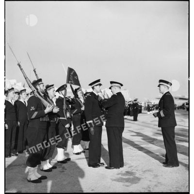 Lors d'une cérémonie, l'amiral François Darlan, haut-commissaire de France en AFN (Afrique française du Nord), remet la Croix de guerre au lieutenant de vaisseau Emile Mine, commandant du sous-marin Marsouin.