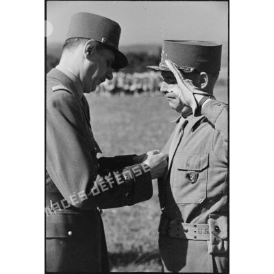 Le général de Gaulle remet au général Juin la plaque de grand officier de la Légion d'honneur.