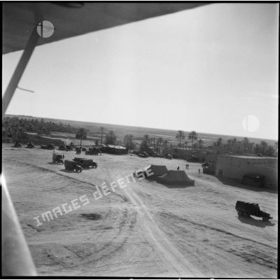 Vue aérienne d'une oasis et d'un campement militaire.
