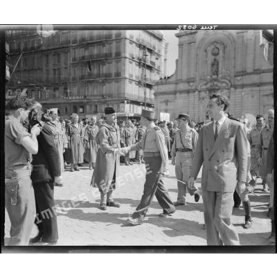 Le général de Lattre de Tassigny félicite un officier lors d'une cérémonie après la libération de Marseille.