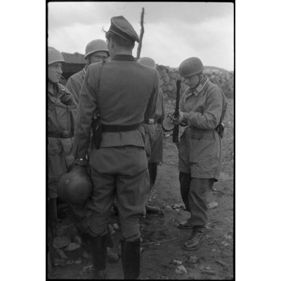 En Norvège, lors d'une démonstration sur l'aérodrome de Banak, un officier de l'armée de terre s'entretient avec des parachutistes allemands.