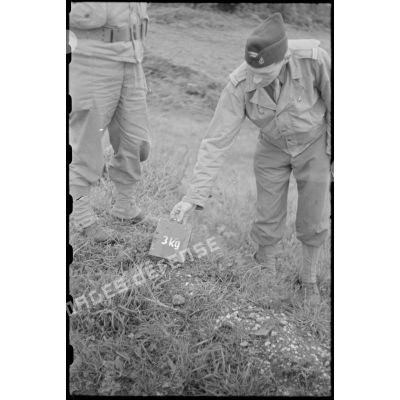 Un lieutenant du 22e groupe colonial des forces terrestres anti-aériennes (22e FTA) montre au photographe une charge explosive.