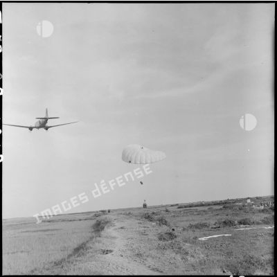 Parachutage de vivres par avion Douglas C-47 Skytrain (Dakota) au milieu des rizières lors de l'opération Brochet.