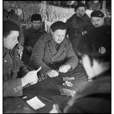 Photographie de groupe de soldats de la 2e armée qui se détendent à l'intérieur d'un abri de campagne.