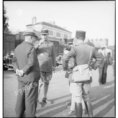 Photographie de groupe d'officiers de la 2e armée qui discutent avec un civil.