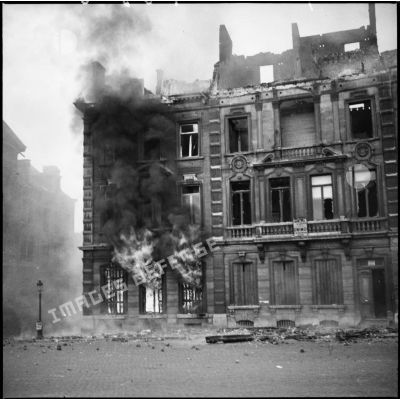 Bâtiments de la place Leopold de Namur en ruines et en feu après les bombradements allemands du 12 mai 1940.