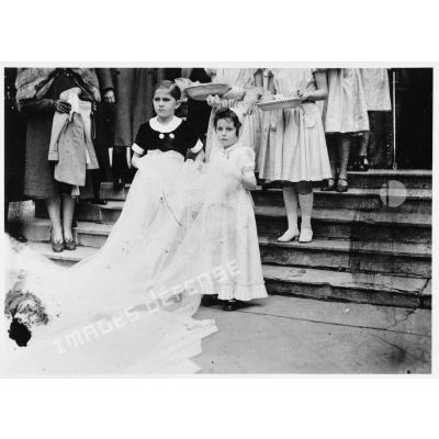 Les demoiselles d'honneur et les enfants qui tiennent la traîne de la mariée sortent de l'église lors du mariage du fils du général Charles Huntziger.