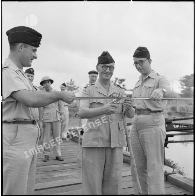 Le colonel Gambiez, commandant la zone delta-nord, coupe le ruban symbolique lors de l'inauguration du pont de Trinh Duc Ha.