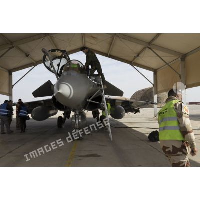 Un pilote de chasse s'apprête à partir en mission depuis la base aérienne projetée (BAP) en Jordanie.