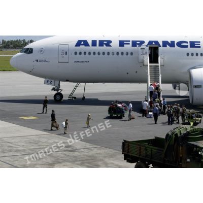 Les ressortissants se dirigent vers l'avion Boeing 777 d'Air France lors de l'évacuation à l'aéroport international d'Abidjan.