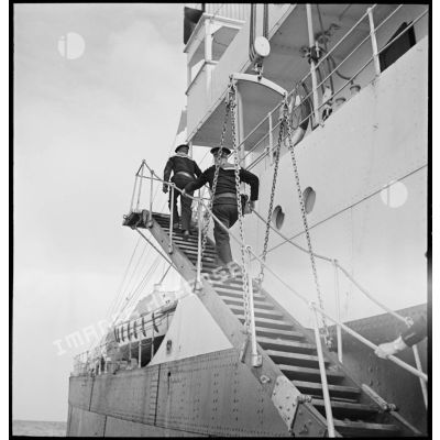 Deux marins de la police de la navigation montent à bord du cargo italien Tagliamento pour un contrôle maritime.