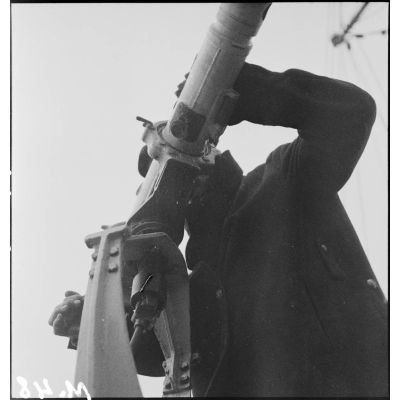 Un télépointeur à bord du contre-torpilleur Le Malin utilise un télémètre pour déterminer la distance d'un objectif.