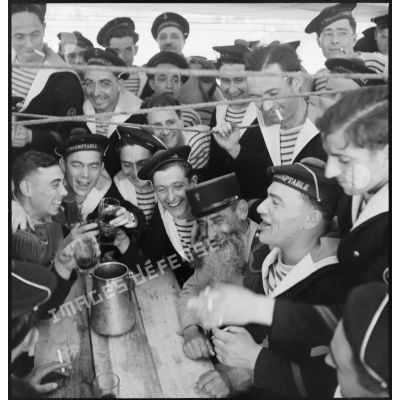 Fraternisation autour d'un verre entre des membres de l'équipage du contre-torpilleur L'Indomptable et des légionnaires du 1er régiment étranger d'infanterie (REI).