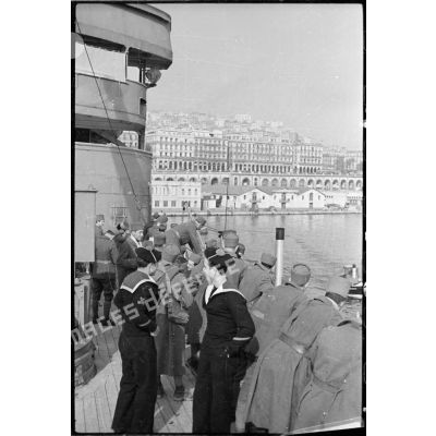 A bord du "Ville d'Alger" des tirailleurs algériens sont appuyés au bastingage et regardent vers la ville d'Alger.