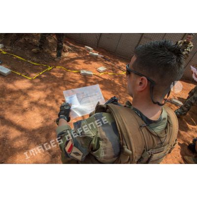 Un soldat analyse le calque d'une carte, lors du briefing des tirailleurs du 1er RT intégrés à la 4e section de la compagnie Rouge du GTIA (groupement tactique interarmes) Turco avant une patrouille à pied dans les environs du village de Mandayeba.
