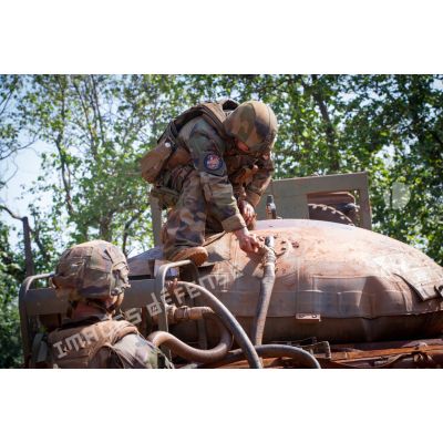 Tirailleurs de la 4e section de la compagnie Rouge du GTIA (groupement tactique interarmes) Turco sanglant un réservoir souple installé sur la plateforme d'un camion TRM-10000 (toutes routes motrices) et relié par une pompe au puits du village de Mandayeba, afin d'approvisionner en eau les troupes basées sur la POD (plateforme opérationnelle défense) de Bambari.