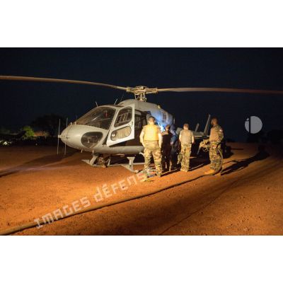 Ravitaillement de nuit d'un hélicoptère AS-550 Fennec du DETFENNEC (détachement d'hélicoptères Fennec) de l'armée de l'Air sur l'aérodrome de la POD (plateforme opérationnelle défense) de Bambari, par les soldats du détachement opérationnel du SEA (Service des essences des armées) du GTIA (groupement tactique interarmes) Turco.