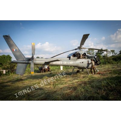 Entretien et reconditionnement de la tuyère d'un hélicoptère Fennec AS-555 du DETFENNEC (détachement Fennec), lors d'un bivouac pendant une patrouille près de la ville de Boda, à 200 Km au nord-ouest de Bangui.