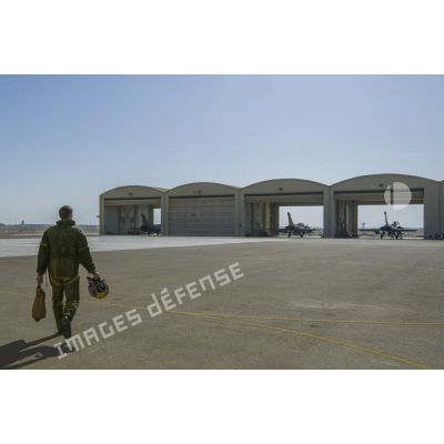 Un pilote se dirige vers les hangars d'avions Rafale pour partir en mission depuis la base aérienne d'Al Dhafra (BA 104), aux Emirats arabes unis.