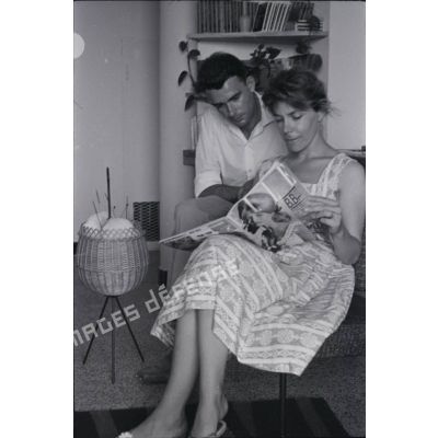 [Algérie, 1954-1962. Un couple photographié dans leur lecture du magazine "Elle" avec Brigitte Bardot à la une.]