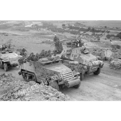Un half-track M2 de prise est dépassé par un blindé Sd.Kfz-263 et un Sd.Kfz-251/1 de la 5e compagnie du Panzer.Grenadier Regiment (Pz.Gren.Rgt-69).