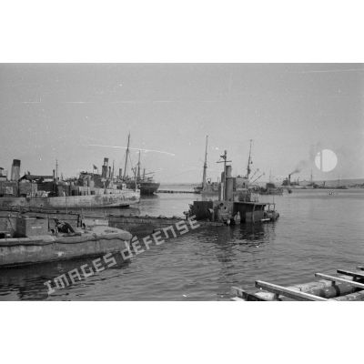 Depuis les quais du port de Tobrouk, des navires britanniques partiellement coulés et des navires allemands et italiens.