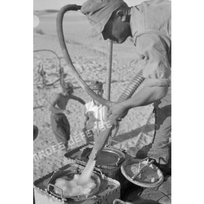 Des soldats remplissent des nourrices d'eau.