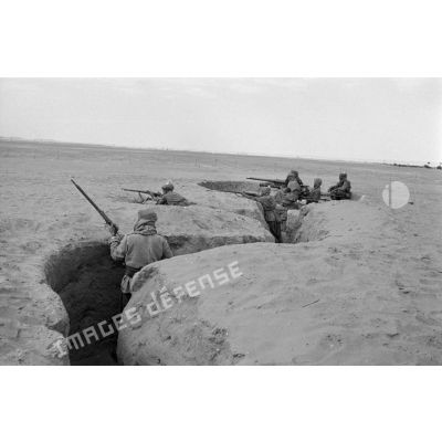 Soldats italiens en position dans leur tranchée.