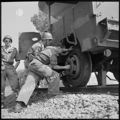 Des soldats de la 1re compagnie du 9e RZ (régiment de zouaves) changent une roue d'un Scout Car.