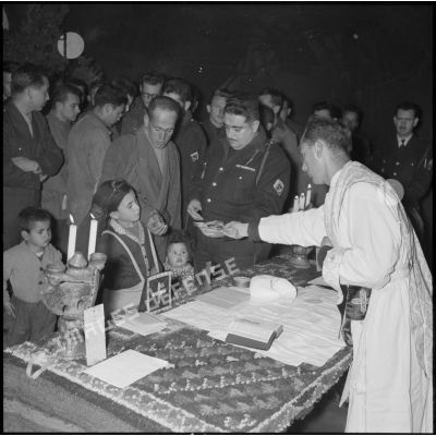 Distribution de l'hostie par l'aumônier militaire à de jeunes kabyles lors de la messe de minuit à Ouadhia.
