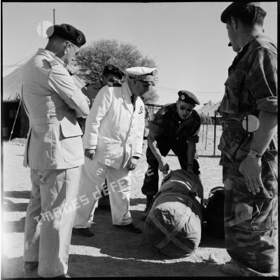 Le vice-amiral d'escadre Barjot s'intéresse à la gaine A 5 pour mortier ou mitrailleuse, au cours de sa visite du camp X (Chypre).
