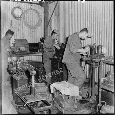 Des soldats de la 407ème compagnie de réparation divisionnaire (CRD) travaillent sur des machines dans l'atelier.