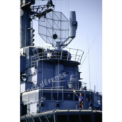 L'îlot du PA (porte-avions) Clemenceau, surmonté d'un radar. Un matelot communique en sémaphore avec le BCR (bâtiment de commandement et de ravitaillement) Var au cours du ravitaillement.