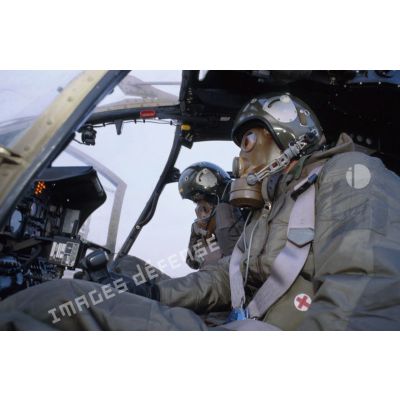 Entraînement au pilotage d'un hélicoptère de combat Gazelle Hot du 5e RHC avec la tenue S-3P (survêtement de protection à port permanent) et l'ANP (appareil normal de protection) pendant un exercice NBC.