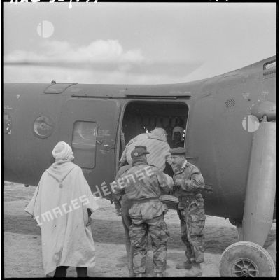 Les commandos font monter des hommes à bord d'un hélicoptère de transport Piasecki H-21.