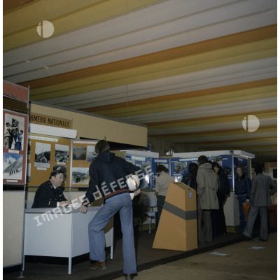 Un homme accueille un étudiant sur un espace du stand de l'exposition Jeunesse 1976, dans l'ancienne gare de la Bastille à Paris.
