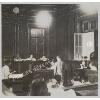 Lors du procès des criminels de guerre japonais, un homme, debout, face au jury.