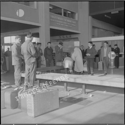 Aérogare de l’aéroport de Maison-Blanche à Alger pendant la grève des transporteurs aériens : contrôle de bagages des civils avant leur évacuation.
