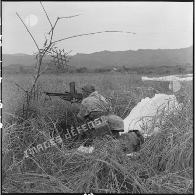 Un parachutiste du 6e bataillon de parachutistes coloniaux (BPC) en position derrière un fusil-mitrailleur après l'atterrissage dans la vallée de Diên Biên Phu, au cours de l'opération astor.