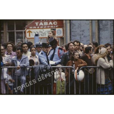 Lors du défilé du 14 juillet 1979 à la Bastille, des gendarmes au milieu du public massé sur les trottoirs.