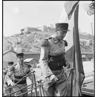 Des légionnaires du 1er régiment étranger d'infanterie (REI) montent à bord du contre-torpilleur L'Indomptable, amarré dans le port d'Oran.
